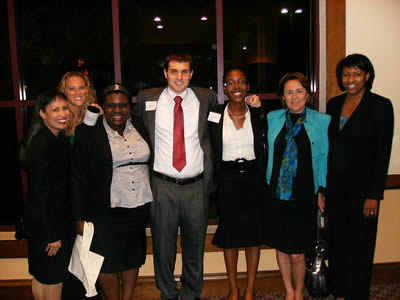 Professionals in business attire in front of large interior window