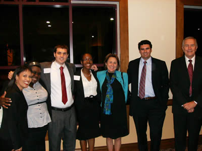 Professionals in business attire in front of large interior window